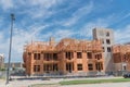 Wooden apartment complex under construction near completed condos and commercial building Royalty Free Stock Photo