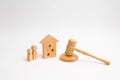 Wooden apartment house with people, keys and a judge hammer on a white background. The concept of laws and regulations for tenants Royalty Free Stock Photo