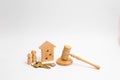 Wooden apartment house with people, keys and a judge hammer on a white background. The concept of laws and regulations for tenants Royalty Free Stock Photo