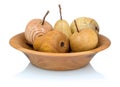 Wooden apples and pears in a fruit bowl made from a different types of wood isolated on white background with shadow reflection.