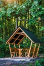 Wooden arbor in the  forest near the lake.Fishing adventures.Camping on the shore of the lake.Carp Fishing Sunset.View of a garden Royalty Free Stock Photo