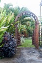 Wooden arbor with gate in garden. Wooden arched entrance to the backyard. Royalty Free Stock Photo