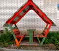 Wooden arbor with two benches and a table