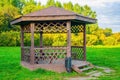 Wooden arbour in park a background of green trees Royalty Free Stock Photo