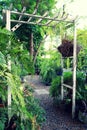 Wooden arch with lush garden Royalty Free Stock Photo