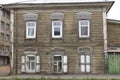 Wooden architecture of Siberia, old Windows with wooden carved architraves. old peeling paint on the wooden Windows Royalty Free Stock Photo