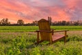 Wooden armchair outdoors in farmland at sunset