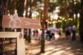 Wooden arrow sign with wedding rings on ceremony venue. Wedding party banner post . Direction info banner for guests in Royalty Free Stock Photo