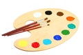 Wooden art palette with paints isolated on a white Royalty Free Stock Photo