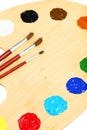 Wooden art palette with paints on the white background Royalty Free Stock Photo