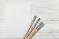 Wooden art palette with tubes of oil paints and a brush. Art and craft tools. Artist`s brush, canvas, palette knife. Space for tex Royalty Free Stock Photo