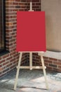 Wooden Artist Easel with Red Blank Mockup Poster for Your Design