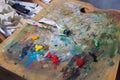 Artist`s palette with extruded paints. Close-up