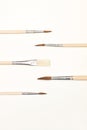 Wooden artistic paintbrushes on a white background