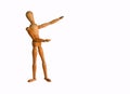 Wooden Artists Manikin doll pointing at copy space