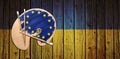 Wooden artists palette loaded with european flag paints on Ukrainian flag Royalty Free Stock Photo