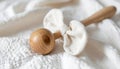 Wooden Baby Rattle on Soft White Fabric in a Neutral Tone Studio Setting Royalty Free Stock Photo
