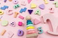 Wooden baby toys on a pastel pink background. Horse, numbers, blocks, puzzle shapes, pyramid, Royalty Free Stock Photo