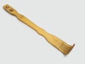 A wooden back scratcher on a white background, a hand shaped itch relief tool with long handle Royalty Free Stock Photo