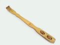 A wooden back scratcher on a white background, a hand shaped itch relief tool with long handle Royalty Free Stock Photo