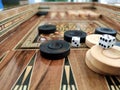 Wooden backgammon board game of pearl inlaid on brown background.