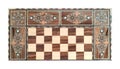 Wooden backgammon board game of pearl inlaid on brown background.