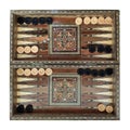 Wooden backgammon board game of pearl inlaid on brown background.