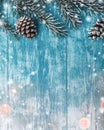 Wooden background of azure, marine. Green fir tree. Decorative cones. Space for Xmas and New Year Message.