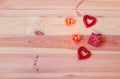 Wooden background with candles, red hearts and gift. Concept of Valentine Day Royalty Free Stock Photo