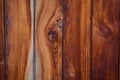 Wooden background, close-up. Brown vertical boards. Facing the exterior walls of the house. Ramshackle wall with peeling paint Royalty Free Stock Photo