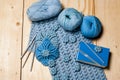 On wooden background elements of crochet, knitted blue lace napkins and knitting tools, balls of yarn and hooks. Hobbies in free Royalty Free Stock Photo