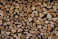 Wooden background. Firewood drying for the winter, stacks of firewood