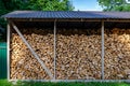 Wooden background. Firewood drying for the winter, stacks of firewood