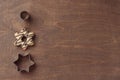 Wooden background with fresh baked homemade star-shaped cookie with chocolate and cookie cutters Royalty Free Stock Photo