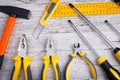 On a wooden background the layout of various construction tools. Top view. Royalty Free Stock Photo