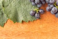 Wooden background with leaf and fresh grape Royalty Free Stock Photo