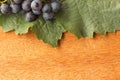 Wooden background with leaf and fresh grape Royalty Free Stock Photo