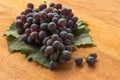 Wooden background with leaf and fresh grape Royalty Free Stock Photo