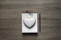 On a wooden background lies a craft notepaper scrapbooking on it cookie heart pencil brown