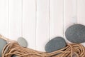 Wooden background with marine rope and sea stones Royalty Free Stock Photo