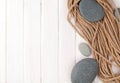 Wooden background with marine rope and sea stones Royalty Free Stock Photo