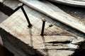 Wooden background. Nails are clogged in a wood old cracked table. solar lighting