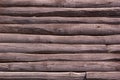 Wooden background. Old log wall. Solid wooden wall from weathered logs