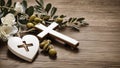 Wooden background with olive heart and white cross for an obituary notice. Royalty Free Stock Photo