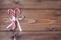 Wooden background with pair of Christmas candy canes