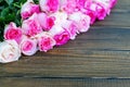 Wooden background with pink roses. A place for congratulations. Royalty Free Stock Photo