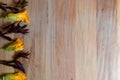 Wooden background with pumpkin flowers and purple epazote, for copy space