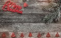 Wooden background. Red Merry Christmas inscription, text space, and a fir tree crest. Top view. Winter items Royalty Free Stock Photo