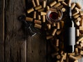 On a wooden background there are a lot of wine corks, a bottle of wine, a wine glass and a corkscrew. Low angle view. Holiday, Royalty Free Stock Photo