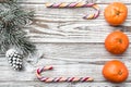 Wooden background. White cone. Fir branch green. Orange. Colorful candy. Winter card, holiday gift. Royalty Free Stock Photo